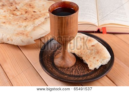Cup of wine and bread on table close-up