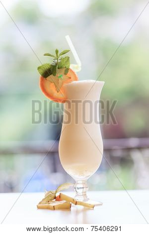 Milk cocktail with orange and carom