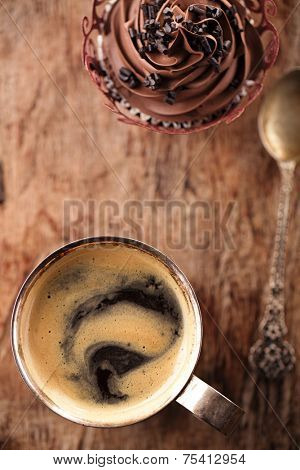 coffee and cupcake in rustic style on wooden table