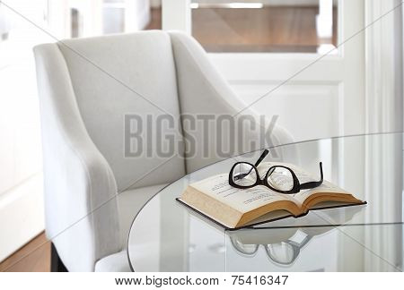 Armchair with Book and Eyeglasses on table