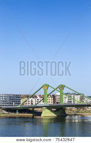 FRANKFURT GERMANY - MARCH 3 2014: View of the city with Floessserbruecke with river Main in Frankfurt Germany. The Floesser bridge was inaugurated in 1984 and has a length of 221 meter.