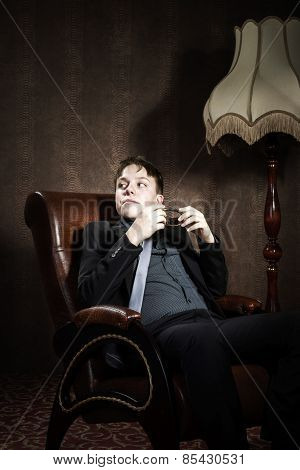 Elegant Teenage Boy Sitting In Arm-chair