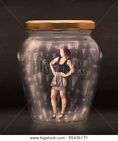 Business woman trapped in jar with exclamation marks concept on bakcground