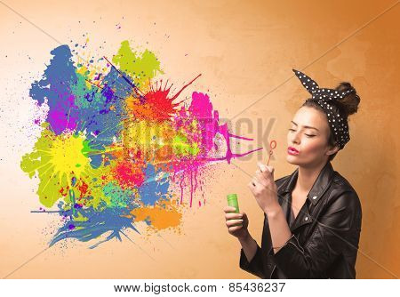 Cute girl blowing bubble spalsh graffiti into wall