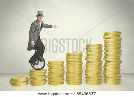 Business man riding monocycle up on coin graph concept on background