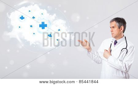 Proffesional doctor listening to abstract cloud with medical signs