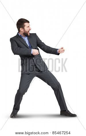 screaming businessman pulling invisible rope. isolated on white background