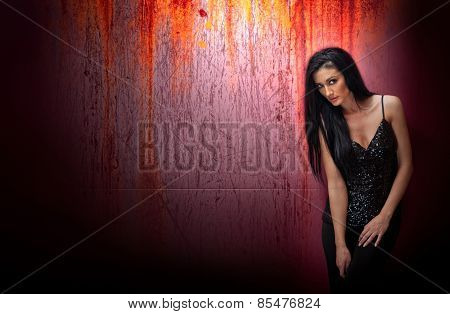 Attractive brunette woman in a black posing dramatic on purple background with red runoffs