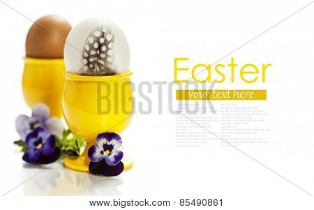 eggs  in yellow eggcups  isolated on white