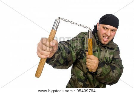 Young man in soldier uniform holding nunchaks isolated on white