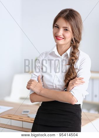 Attractive businesswoman with her arms crossed stnding