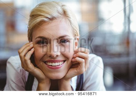 Selfassured female cook smiling in front of her bakery