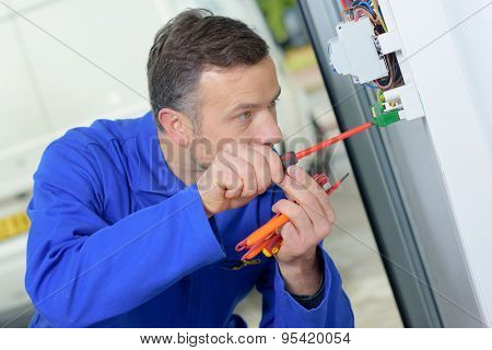 Electrician prodding around at a fusebox