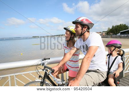 Family on a biking journey by the sea