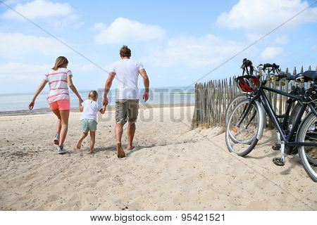 happy family running on a sandy beach
