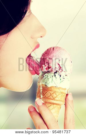 Young woman eating tasty ice cream