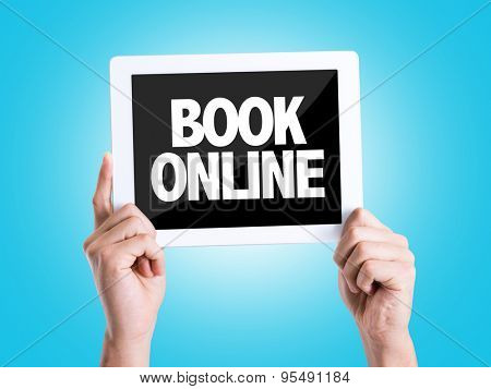 Tablet pc with text Book Online with blue background