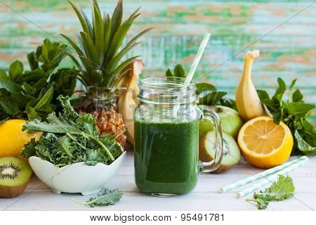 Fresh kale fruit smoothie in a jar with ingredients