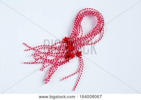 Many holiday Bulgarian Martenitsa spring sign red and white braslets on white background
