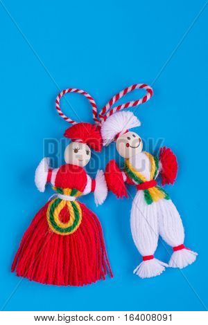 Bulgarian Martenitsa spring sign on blue background