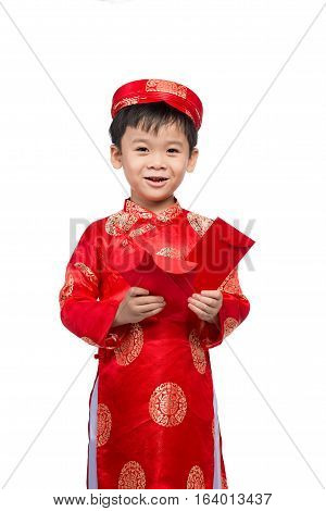 Little Vietnamese boy holding red envelops for Tet. The word mean double happiness. It is the gift in lunar new year or Tet Holiday on red isolate background.