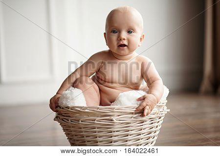Little Baby Sits In A Wicker Basket.