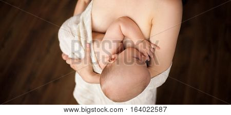 Mother is breastfeeding her baby. Close up.