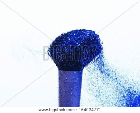 soft cosmetics brush with blue sparkle glister isolated on white copy space