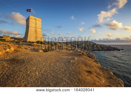 Malta - Ghajn Tuffieha watchtower at Golden Bay before sunset