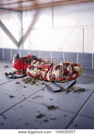 Pair of dirty football shoes. Soccer boots in a dressing oom