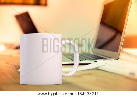 Mockup Styled Stock Product Image white mug that you can add your custom design/quote to. Mug is in front of two open laptops.