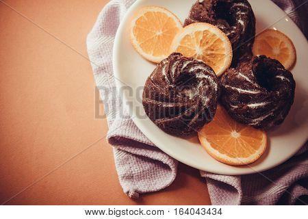dark chocolate muffins with fruits on plate