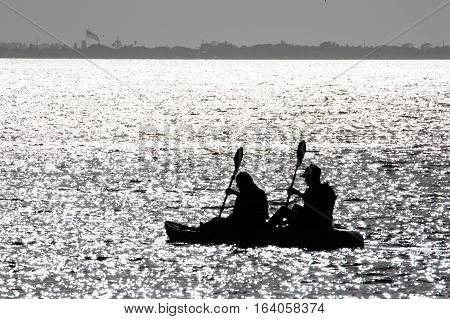 Silhouette Of Two People Rowing at the lake