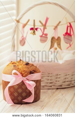 Easter cake and basket with eggs and Easter decor.