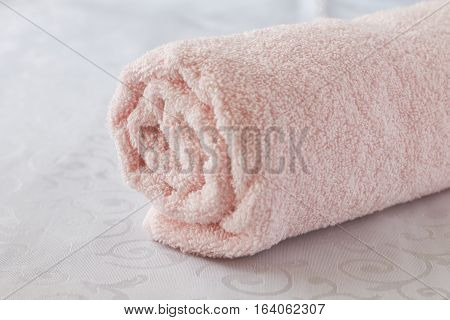 Twisted bath towel on a white background
