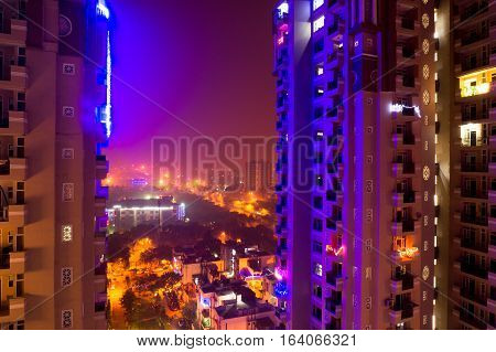 colorful lights on a skyscraper in Noida Delhi India on the eve of diwali. Urbanization of the city has given a rise to many residences
