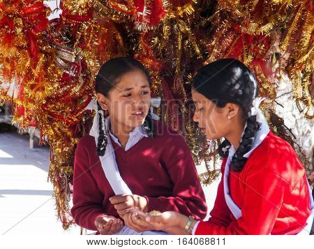 DHARAMSALA, INDIA. 2 Jun 2009: Daily lifestyle. Hindu school girls in the temple, pray before a test in school. Western Himalayas, Himachal Pradesh, district of Kangra.
