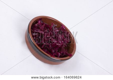 photo of pot of red coleslaw isolated on a white background