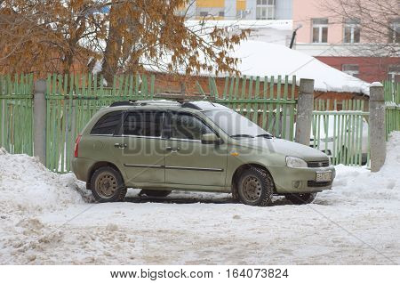 SARANSK, RUSSIA - JANUARY 1, 2017: Lada Kalina station wagon parked on the yard house.