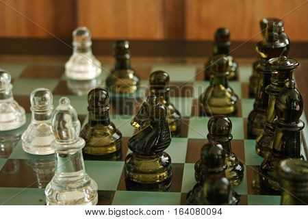 Glass chess pieces that were photographed mid game.