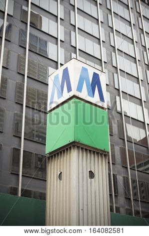 A metropolitan transit authority sign indicating a subway station in New York City.