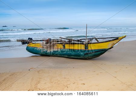 Fishing boat on the sand beach. Indian ocean. Sri Lanka.