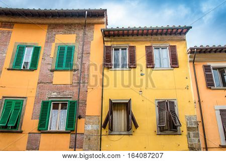 Three old italian houses with the shutters. Pisa, Italy.