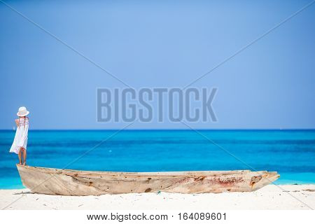 Adorable happy smiling little girl on boat in the sea
