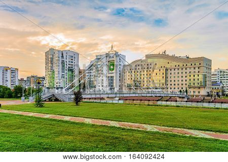 BELGOROD RUSSIA - JULY 04 2016: Pedestrian bridge over river Vezelka on the campus of Belgorod State University. View of the university hostel and left-bank residential neighborhood.
