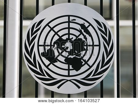 New York, July 19, 2016: A black and white UN logo attached to a fence of the United Nations campus.