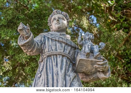 Old stone statue of the Saint Anthony in village Tucepi in Dalmatia.