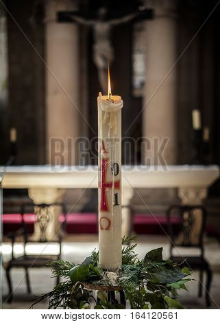 Portugal Alcobasa. Monastery of Santa Maria de Alcobasa - interior and interior decoration . Large candle on the background of the crucifixion.