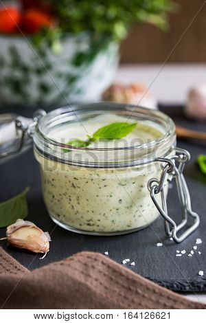 Homemade Basil dressing in a jar by fresh ingredients