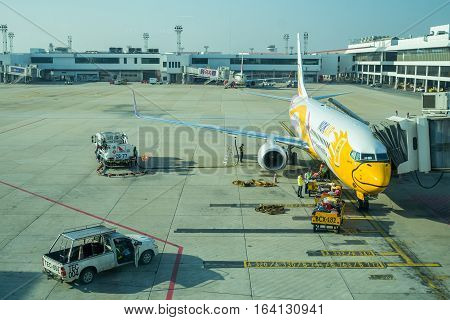 BANGKOK, THAILAND-DEC 29 2016. NOKAIR airline loading cargo on the plane at the gate in Don Mueang international airport (DMK)